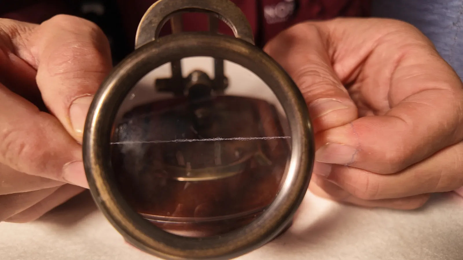 A wool thread examined under a thread-counter lens: microns measure fibre diameter